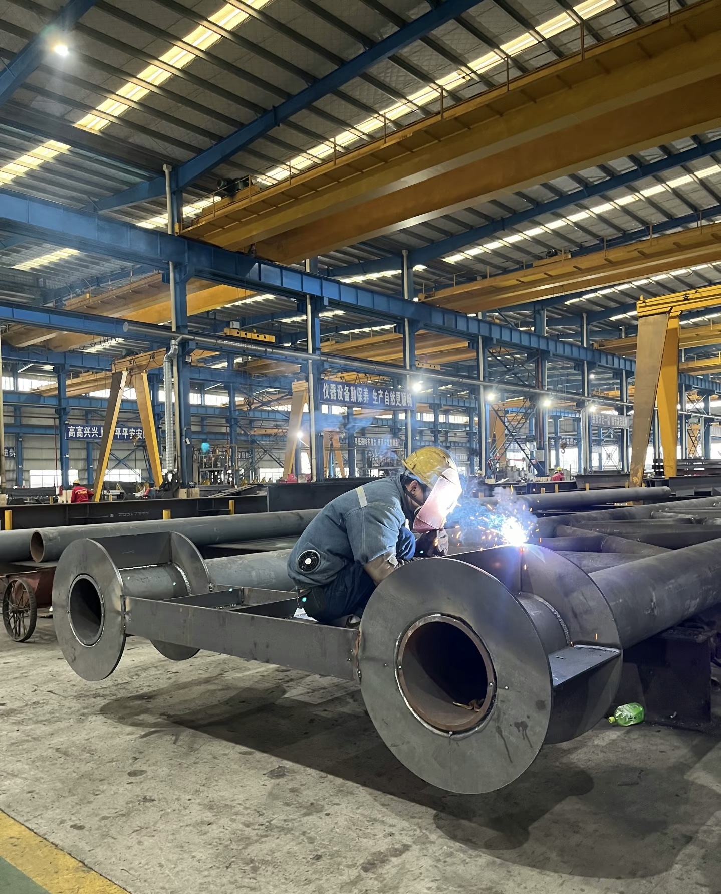 workers processing stainless and carbon steel materials in HaiHong Steel factory workshop